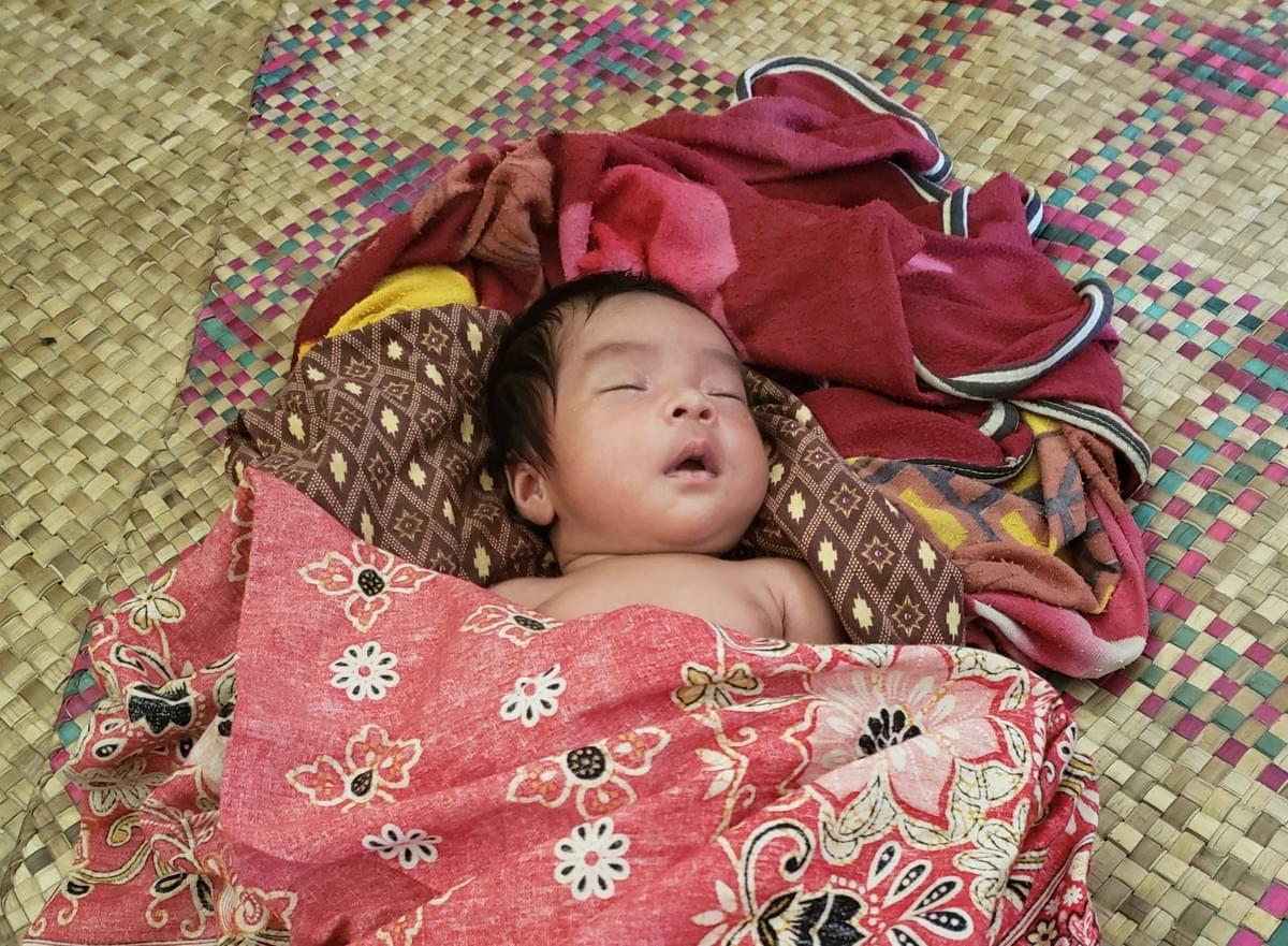 Precious Cambodian newborn resting comfortably in home constructed with supplies donated by MTRF Precious Cambodian newborn resting comfortably in home constructed with supplies donated by MTRF